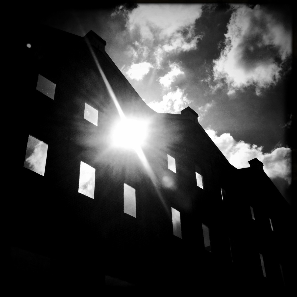 Dramatic black and white photograph oath façade of old warehouses in Amsterdam